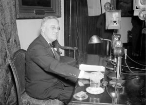 President Franklin Delano Roosevelt (FDR) just before his April 28, 1935 Fireside Chat, his weekly radio talk with the American people. The President is preparing to announce that he has just signed the bills creating Social Security and the WPA, the most important of his administration's New Deal programs to pull the United States out of the Great Depression. Photo from the Harris & Ewing collection at the Library of Congress.